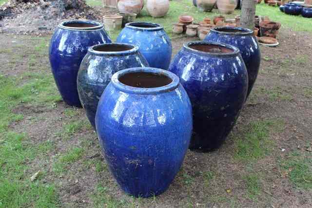 Appraisal: A GROUP OF SIX BLUE GLAZED OVOID PLANTERS each approximately