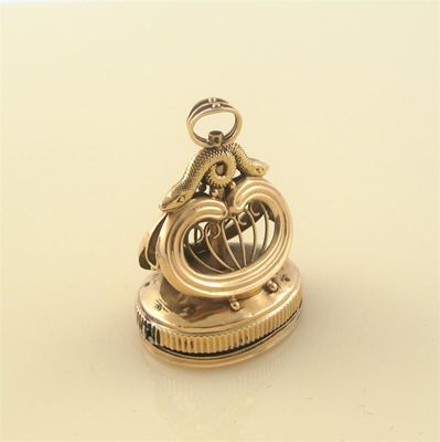 Appraisal: A gold musical fob seal the oval plain matrix with