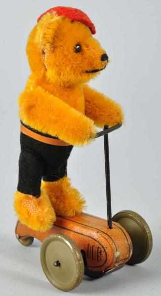 Appraisal: Schuco Teddy Bear on Scooter Wind-Up Toy Description German Working