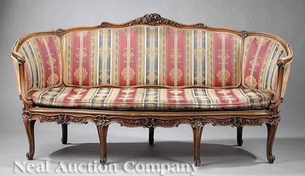 Appraisal: A Louis XV-Style Carved Walnut Canap the scalloped back with