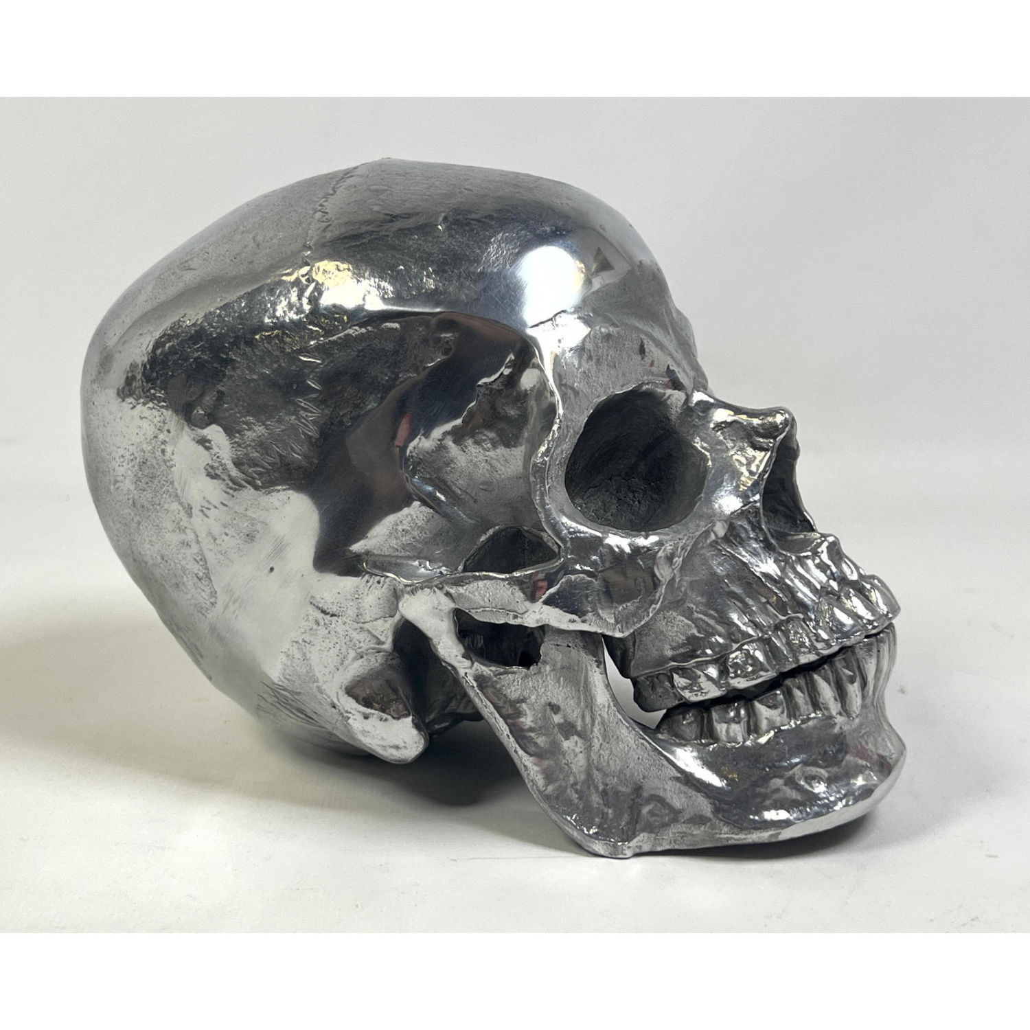 Appraisal: Silvered Aluminum Human Skull form Sculpture Dimensions H inches W