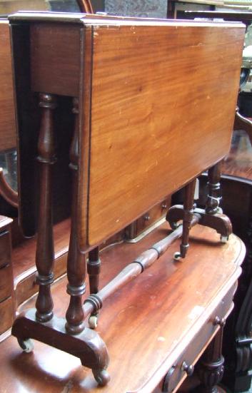 Appraisal: A late Victorian walnut sutherland table the rounded rectangular drop-leaf