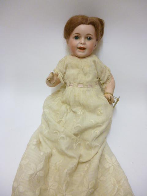 Appraisal: An SFBJ Laughing Jumeau bisque head character doll with blue