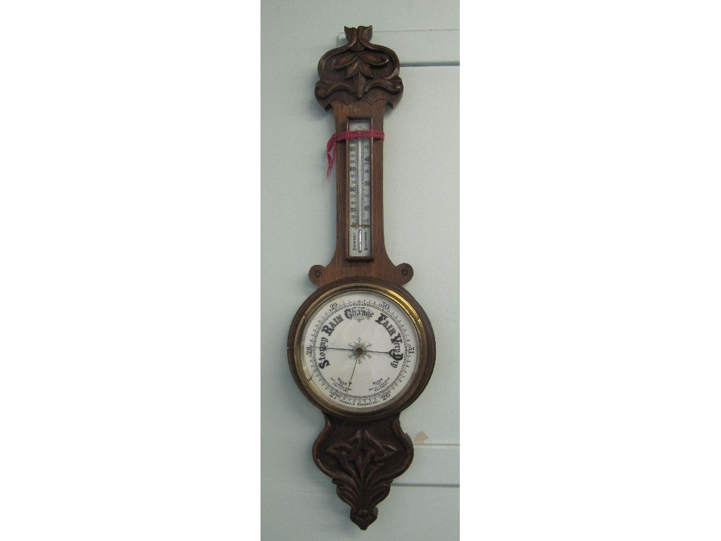 Appraisal: A Victorian oak aneroid banjo barometer with a white enamel