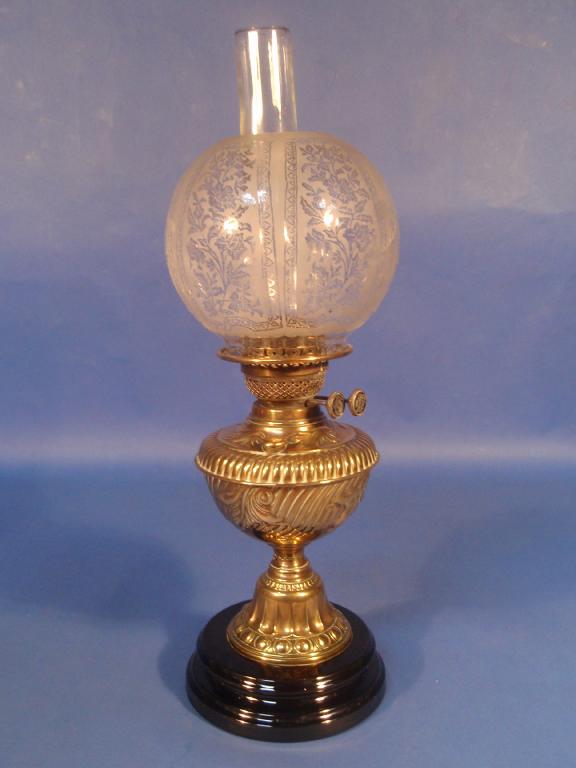 Appraisal: A Victorian embossed brass oil lamp with double burner etched