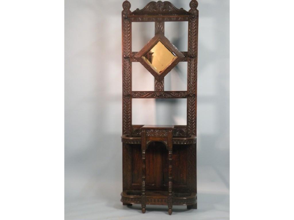 Appraisal: A carved oak hall stand with a central lozenge shaped