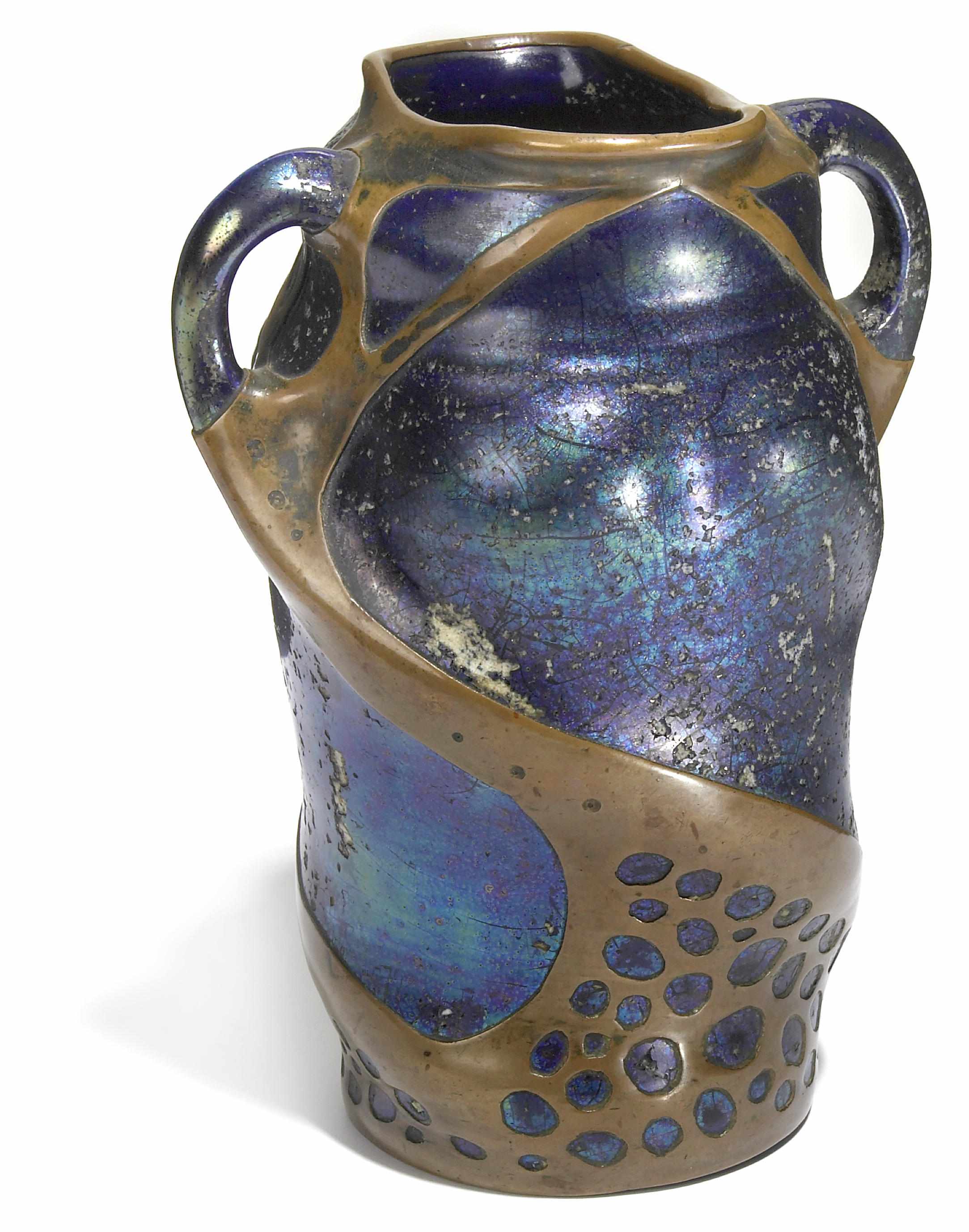 Appraisal: An Austrian copper overlaid blue lustre glazed earthenware two-handled vase