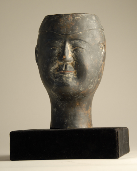 Appraisal: A Chinese Han Style Pottery Head colored with black pigment