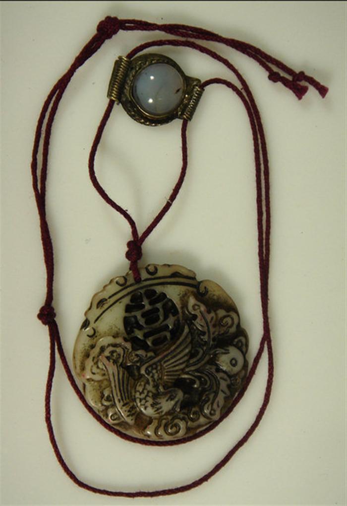 Appraisal: Carved bird jade pendant on cord silver slide h Estimate