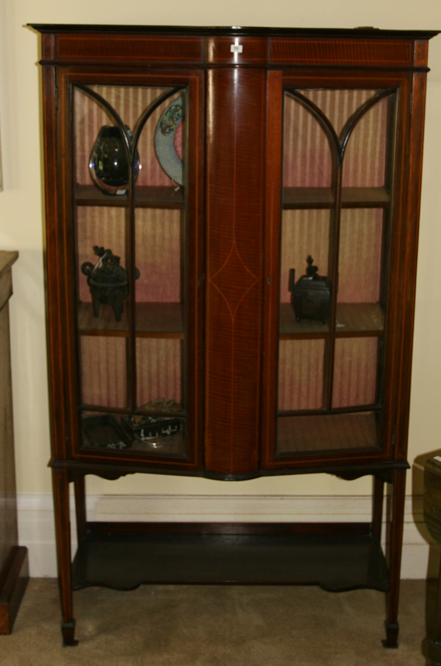 Appraisal: An Edwardian display cabinet in satinwood the bowed crossbanded central