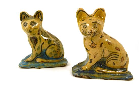 Appraisal: Two th C folk art glazed pottery cat figurines mustard-colored