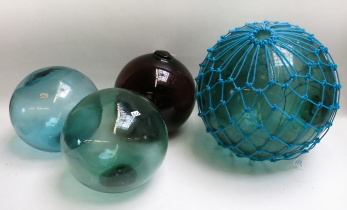 Appraisal: FOUR JAPANESE GLASS FISHING FLOATS red and blue-green glass one