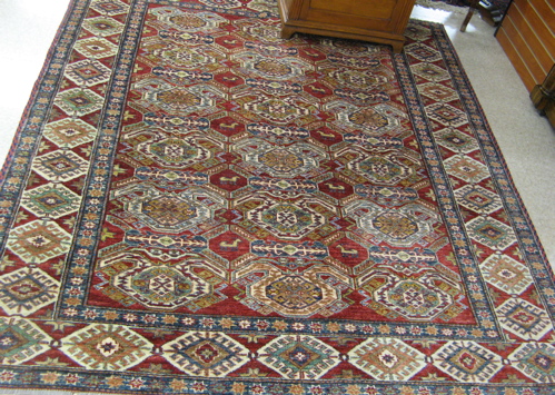 Appraisal: PAKISTANI-CAUCASIAN AREA RUG overall geometric design on red ground hand