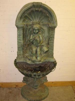 Appraisal: A WALL FOUNTAIN in bronzed metal modern comprising cherub holding