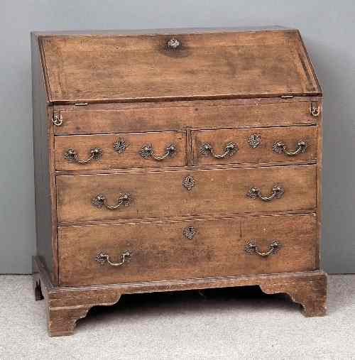 Appraisal: An th Century oak bureau the slope enclosing five small