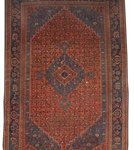 Appraisal: AN OLD PERSIAN RED AND BLUE GROUND SMALL CARPET decorated