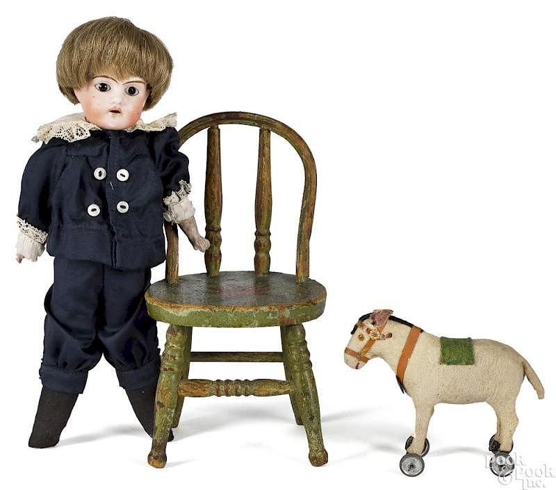 Appraisal: German bisque head boy doll with chair German bisque head