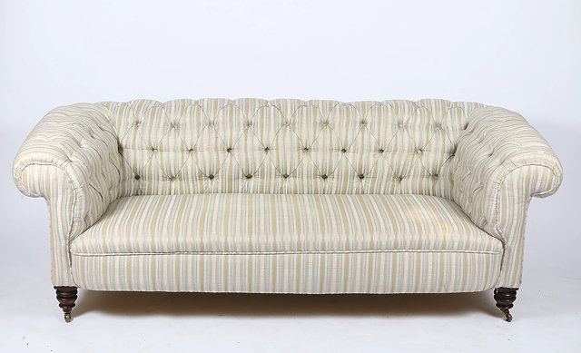 Appraisal: A VICTORIAN BUTTON BACK STRIPED UPHOLSTERED CHESTERFIELD SOFA with rollover