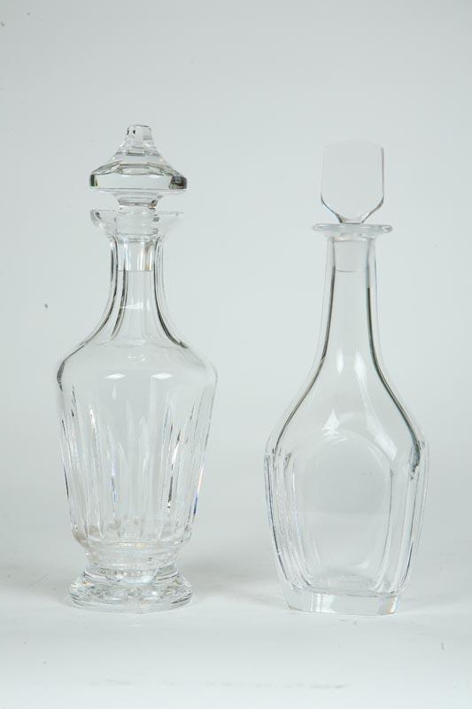 Appraisal: TWO GLASS DECANTERS Clear glass paneled body with a flared