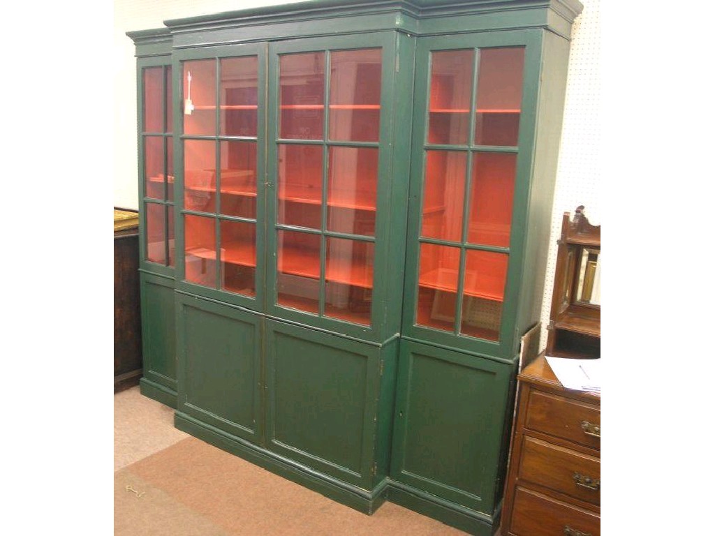 Appraisal: A green painted pine break-front bookcase two pairs of glazed