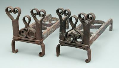 Appraisal: Pair hand wrought iron andirons cutout scrolled hearts above shaped