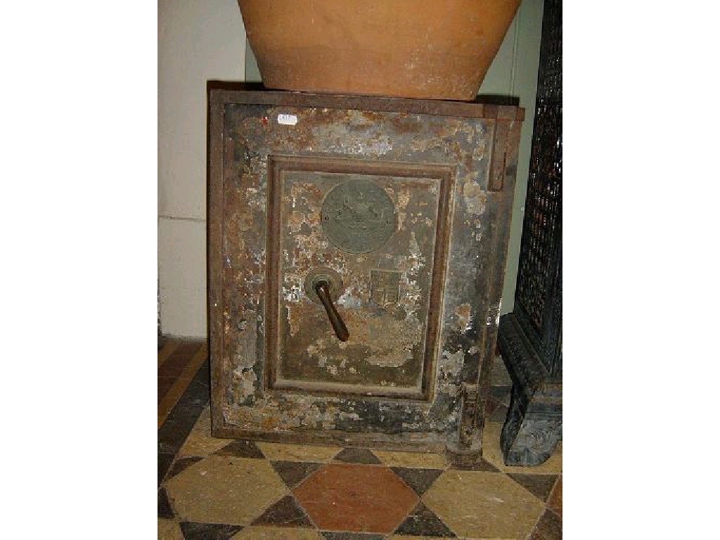 Appraisal: A small Victorian cast iron safe enclosed by a single