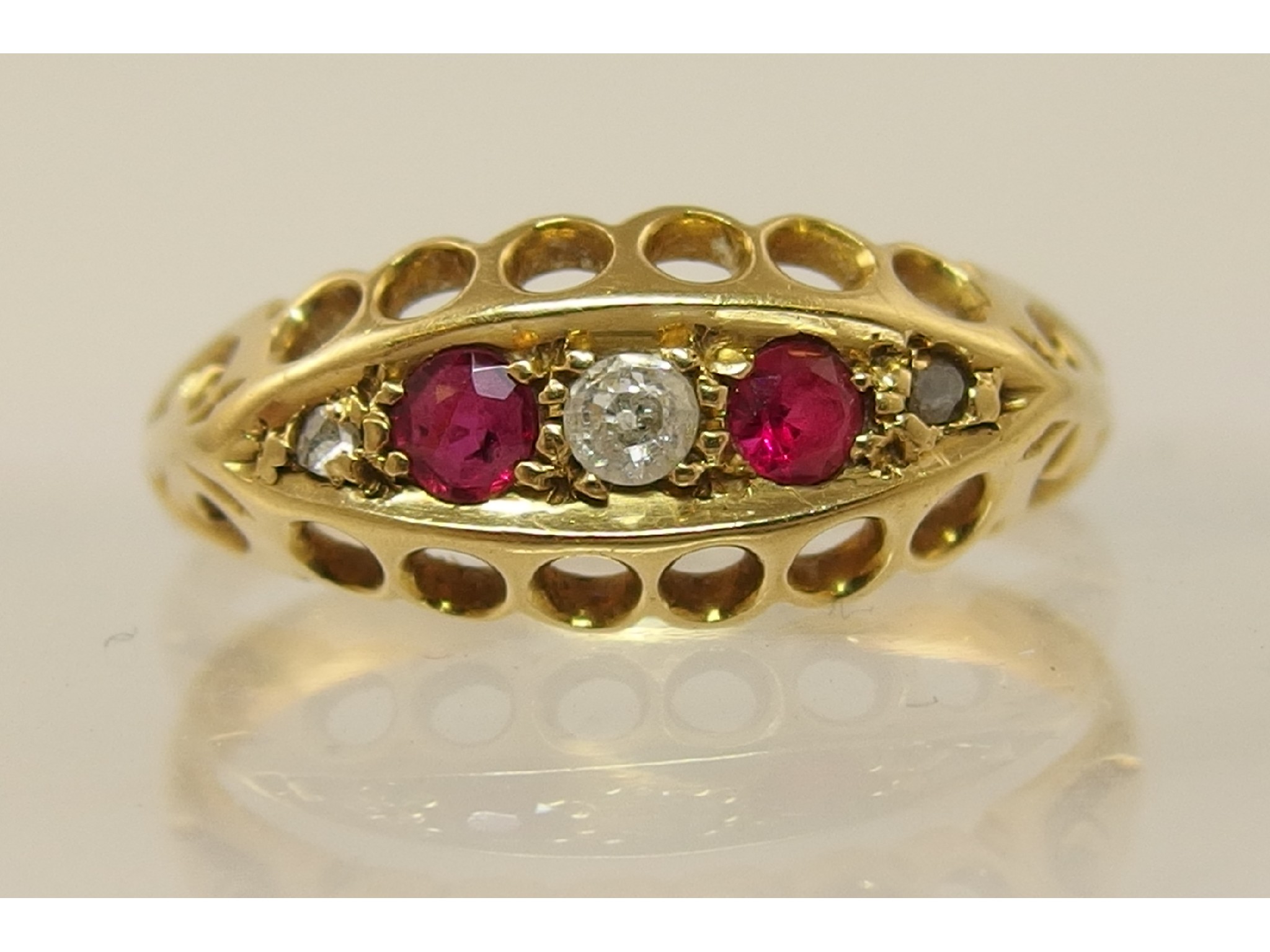 Appraisal: An ct diamond and red gem stone five stone ring