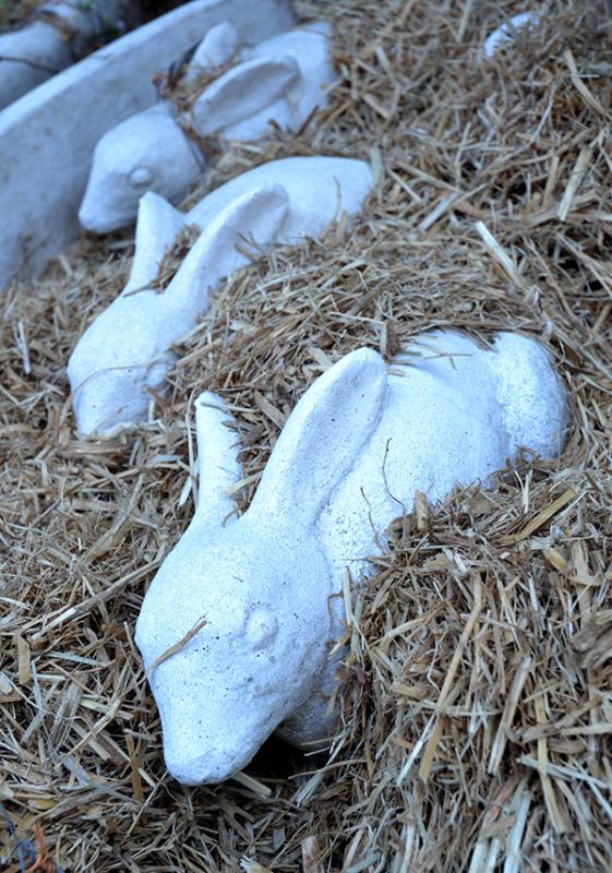 Appraisal: A COLLECTION OF NINE CONCRETE RABBIT FIGURINESvarious sizes the largest