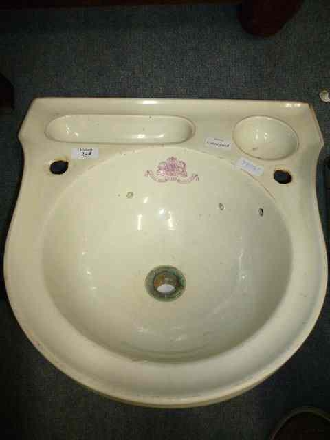 Appraisal: A VICTORIAN POTTERY WASH BASIN with worn puce line decoration