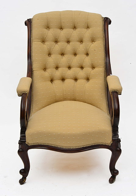 Appraisal: A REGENCY MAHOGANY LIBRARY CHAIR with button upholstered back and