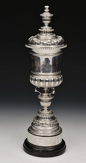 Appraisal: A SILVER LIDDED TROPHY with profuse embossed decoration on pedestal