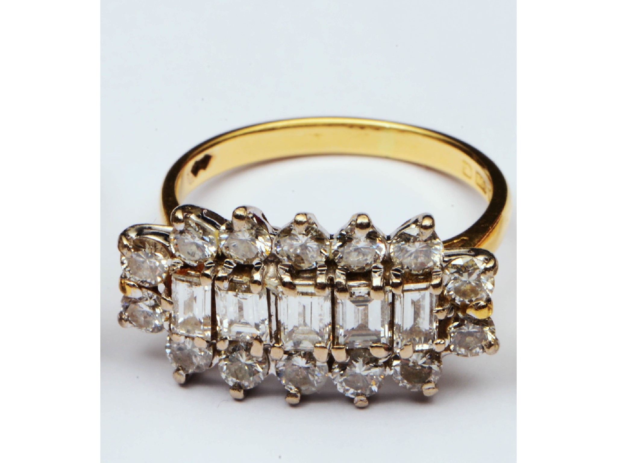 Appraisal: A diamond cluster ring centred with a row of five