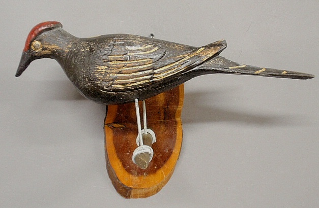 Appraisal: - Hanging folk art carved and paint decorated bird late