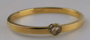 Appraisal: Chopard yellow metal hinged bangle with happy diamonds heart in