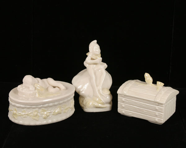 Appraisal: Belleek porcelain figural pieces acorn finial wood chest slumbering bisque