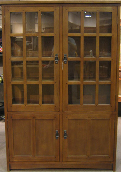 Appraisal: ARTS CRAFTS STYLE BOOKCASE CABINET with a pair of glass