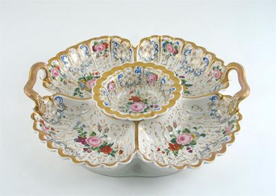 Appraisal: A German porcelain centrepiece with a removable centre decorated in