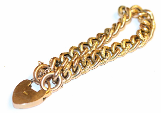 Appraisal: A CT GOLD CURB LINK BRACELET with engraved links and