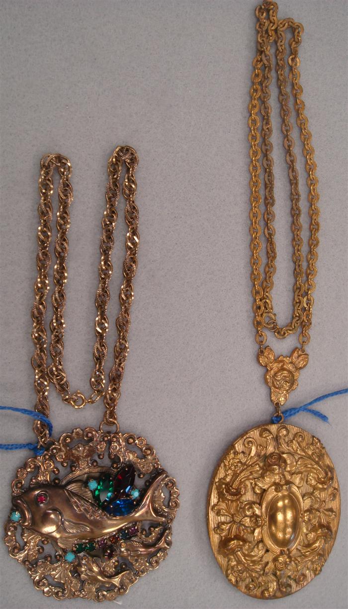 Appraisal: ornate pendants suspended on chains featuring a fish with colored