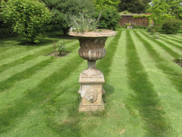 Appraisal: A terracotta campana garden urn with Bacchanalian frieze on a