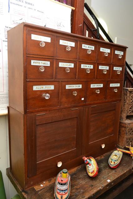 Appraisal: AN EARLY TH CENTURY CEDAR CHEMIST'S CABINET WITH FOURTEEN DRAWERS