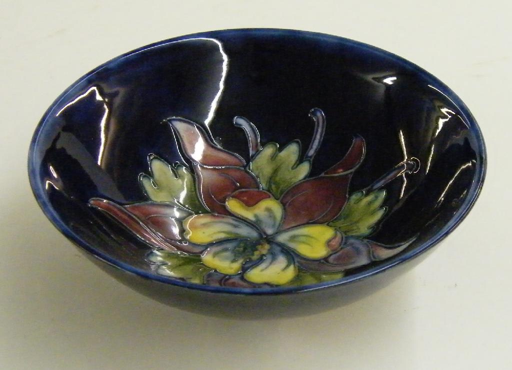 Appraisal: Moorcroft 'Columbine' design circular footed bowl decorated upon a blue