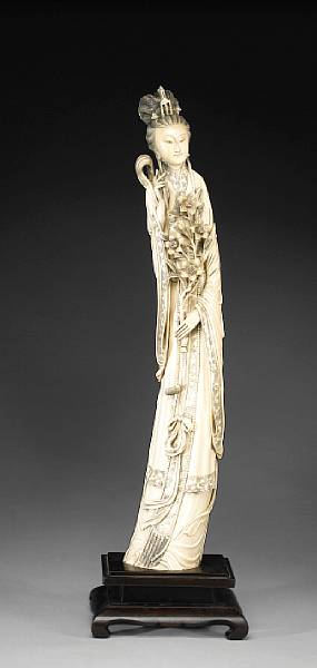 Appraisal: A tinted carved ivory Beauty th Century Standing dressed in