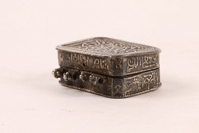 Appraisal: AN ISLAMIC SILVER MINIATURE KORAN CASE OR LOCKET with inscriptions