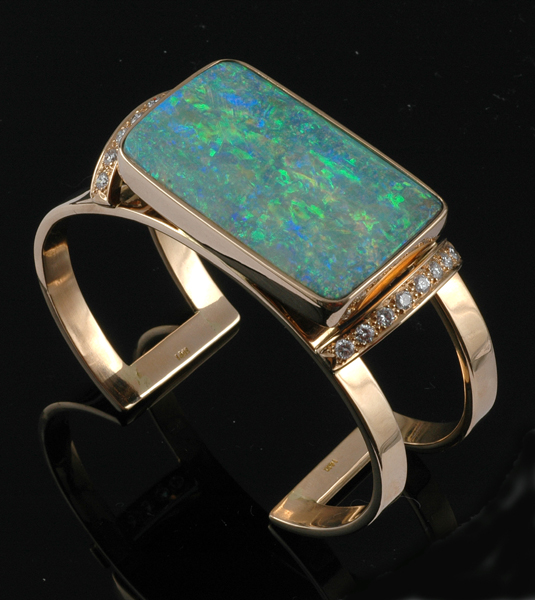 Appraisal: A QUEENSLAND BOULDER OPAL AND DIAMOND BANGLE Crafted in ct