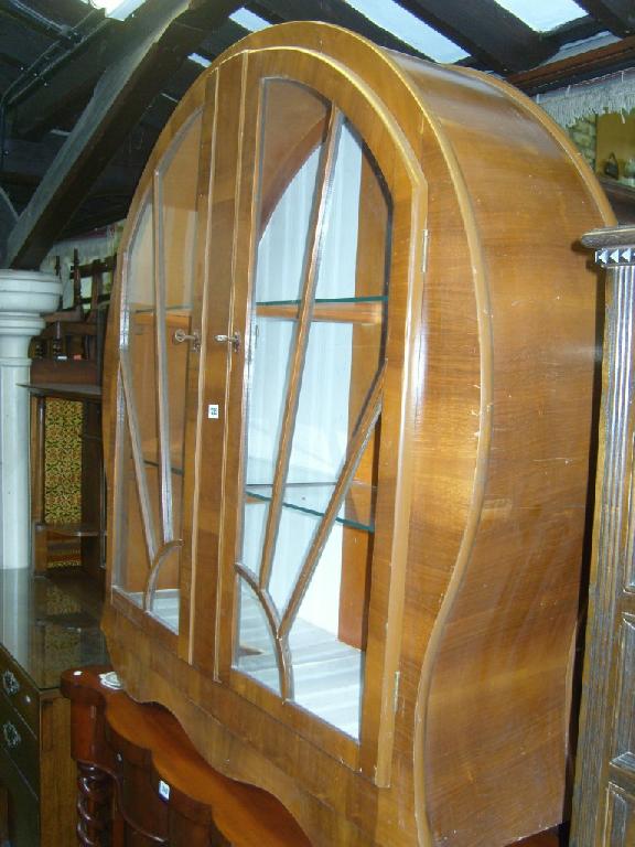 Appraisal: A 's walnut veneered display cabinet of circular form enclosed