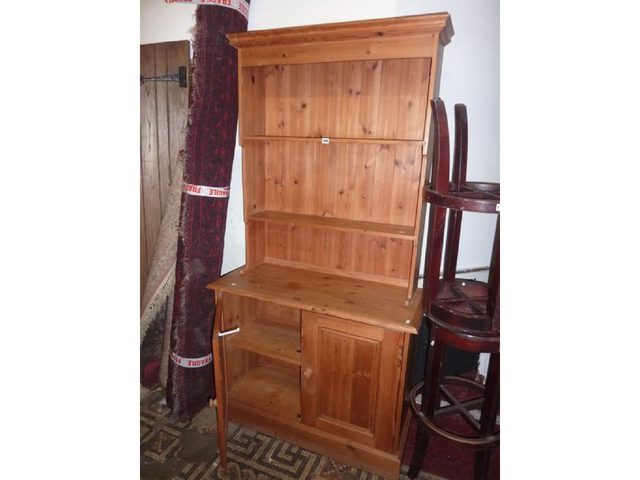 Appraisal: A pine dresser the lower section enclosed by two panelled