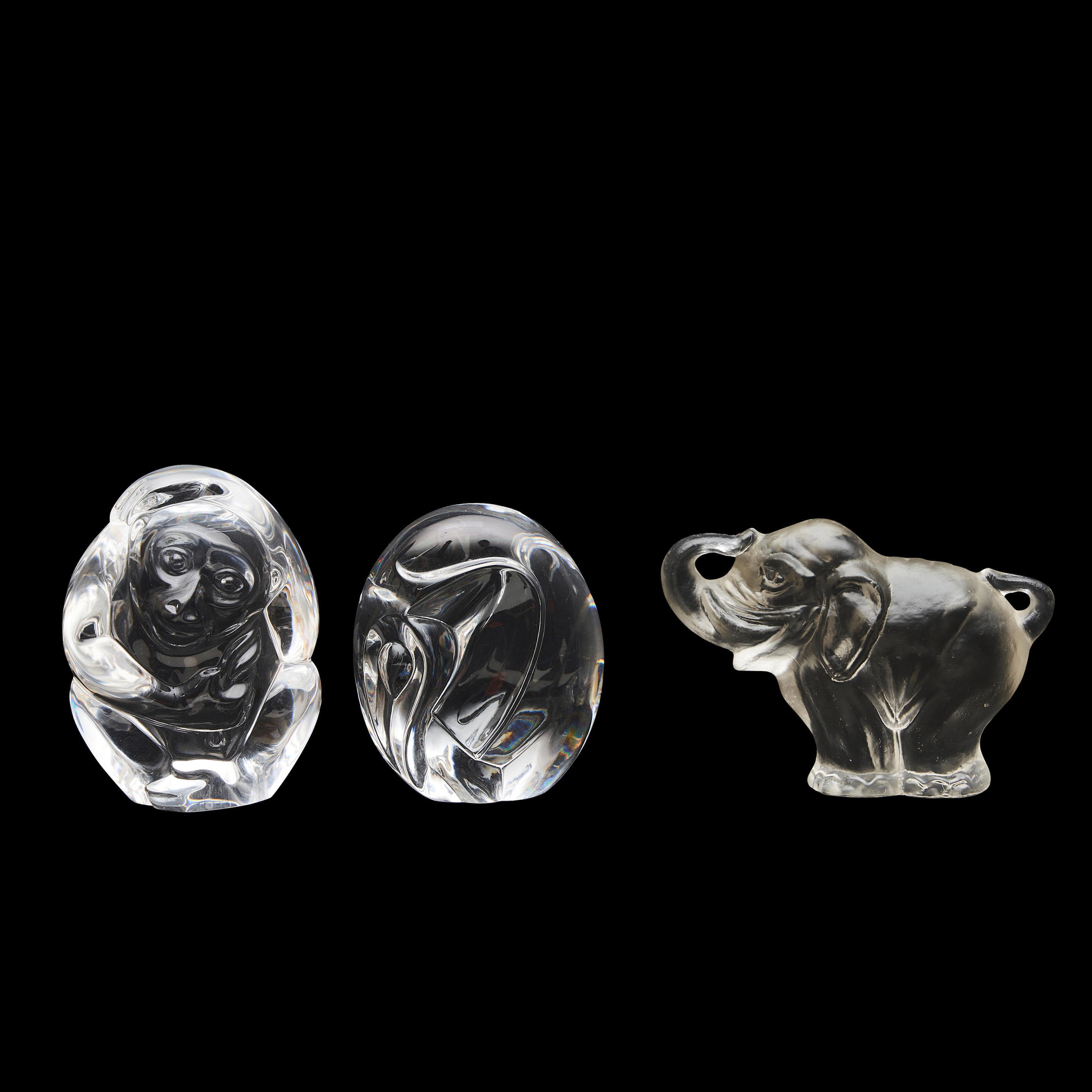 Appraisal: THREE COLORLESS GLASS HAND WARMERS a Steuben elephant a Steuben