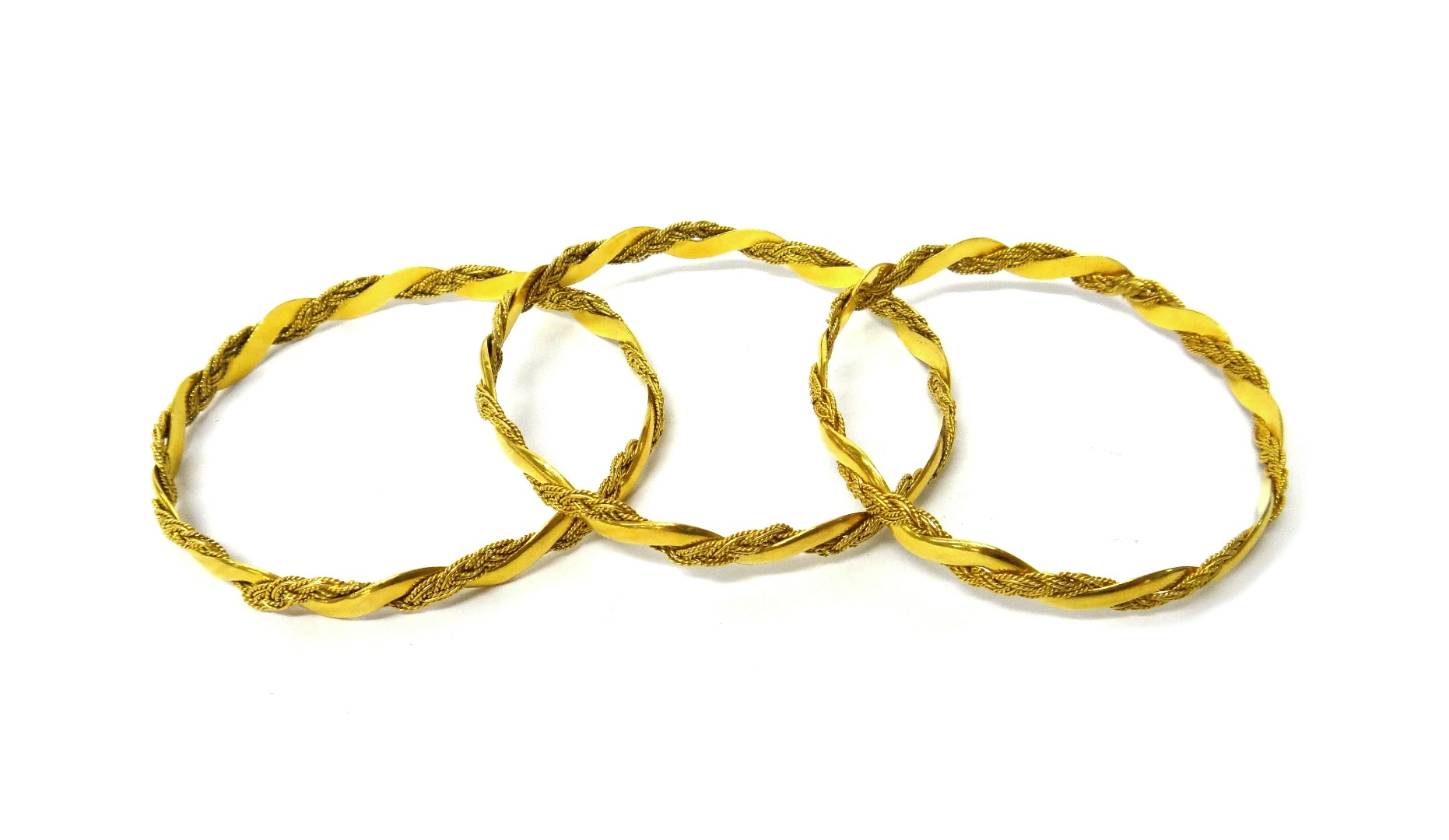 Appraisal: Three gold circular bangles each in a ropetwist interwoven wirework