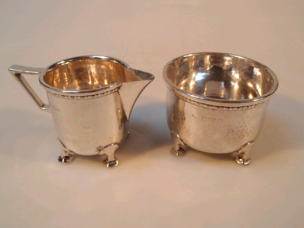 Appraisal: A silver sugar bowl and milk jug hammered finish on